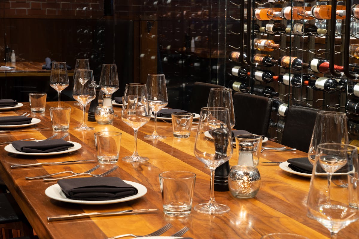 a group of people sitting at a table with wine glasses