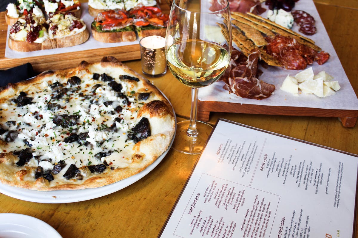 a pizza sitting on top of a wooden table