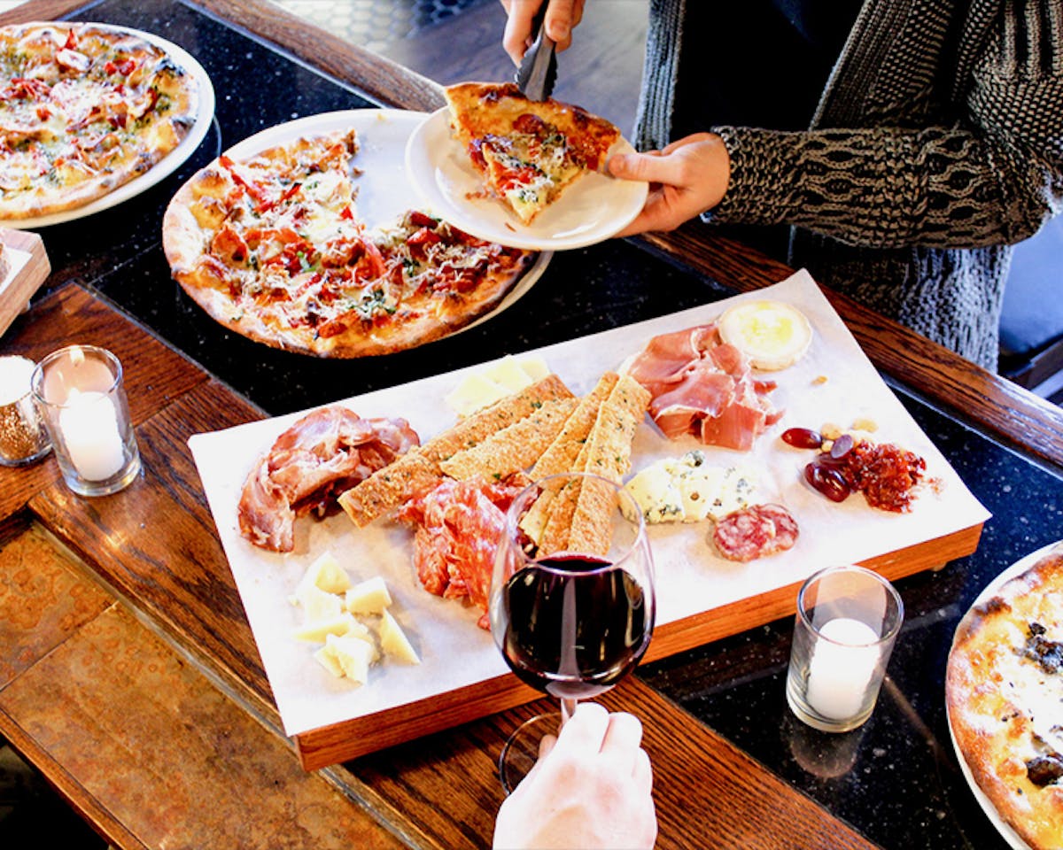 a pizza sitting on top of a wooden table