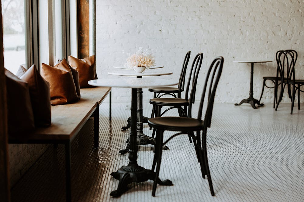 a dining room table in front of a window