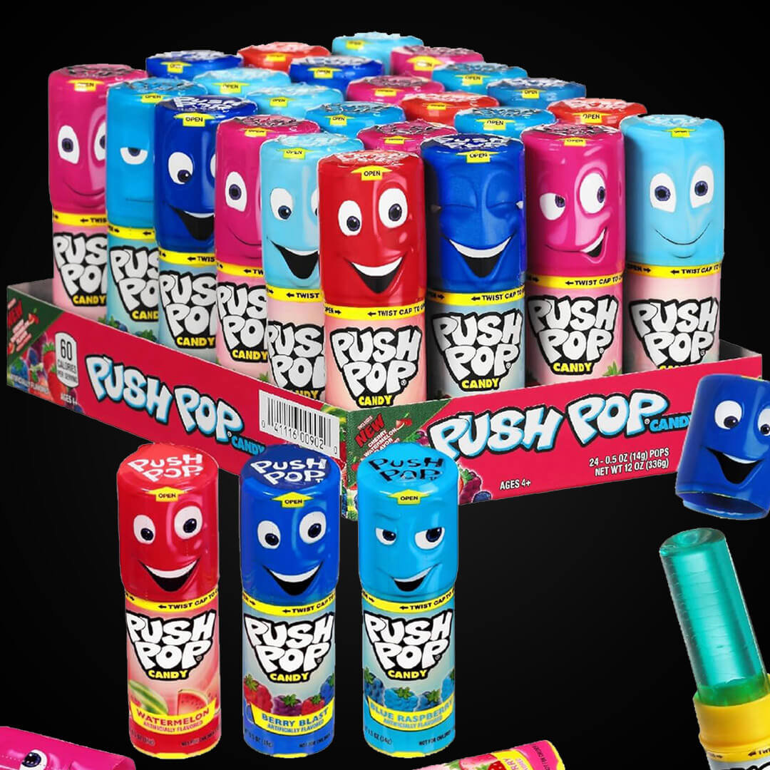 A full retail display box of Push Pop lollipops featuring blue raspberry, watermelon, and berry blast flavors with cartoon faces on the packaging.