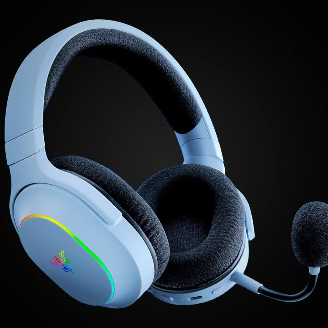 A light blue over-ear wireless gaming headset with plush dark grey ear cups, an attached microphone, and subtle RGB lighting.