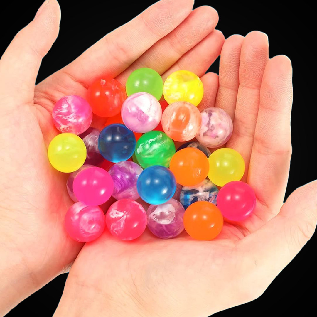 Two open hands cupping a large pile of small, colorful rubber bouncy balls in swirling translucent and neon shades.