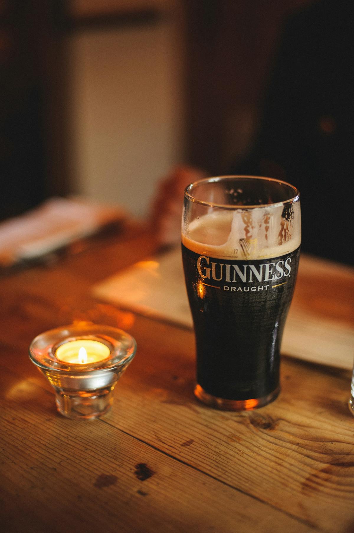 a close up of a glass of beer on a table