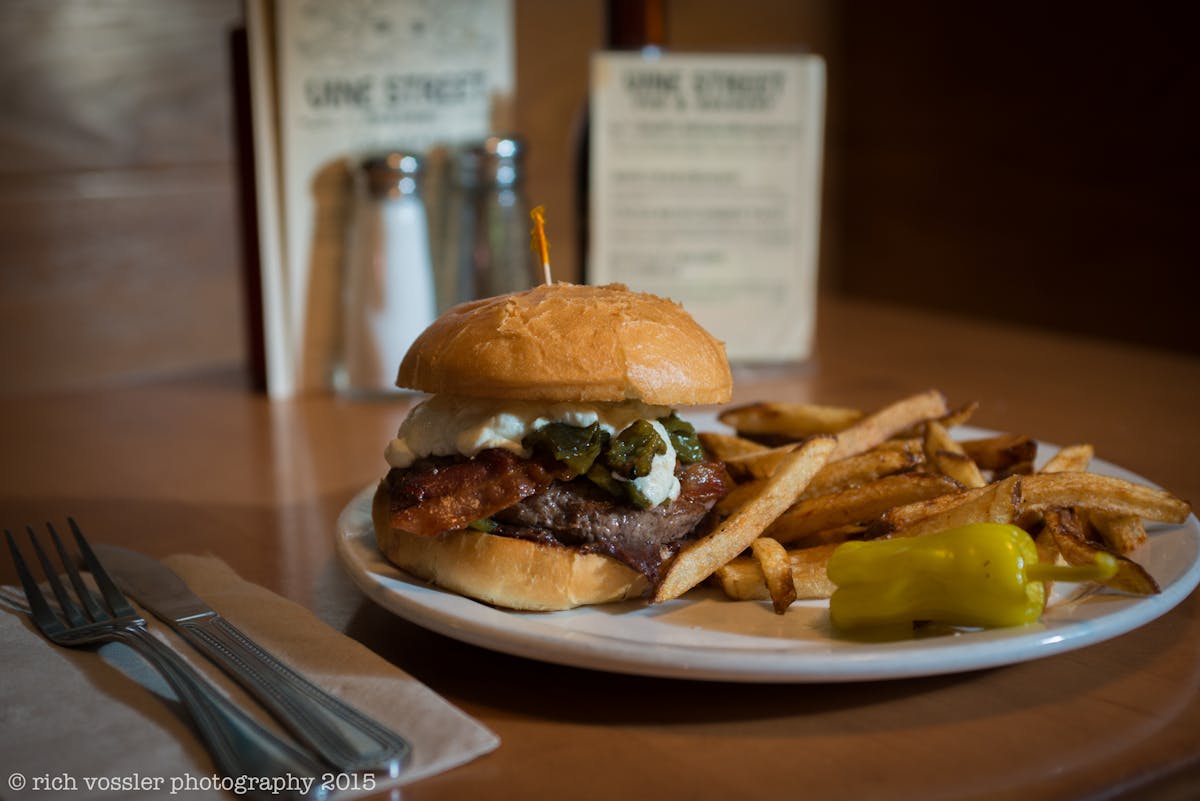 a sandwich sitting on top of a plate of food on a table