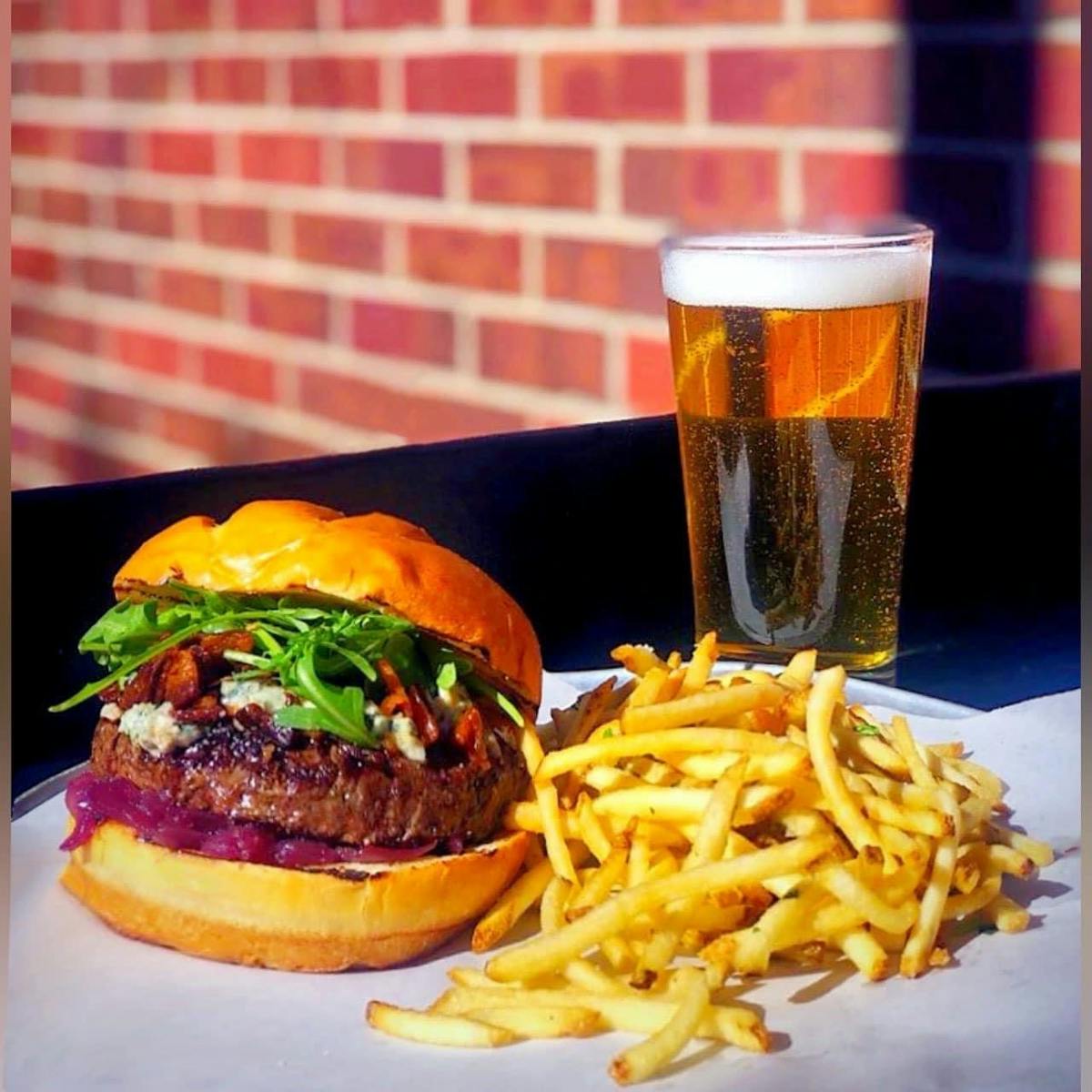 a close up of a sandwich and fries on a table