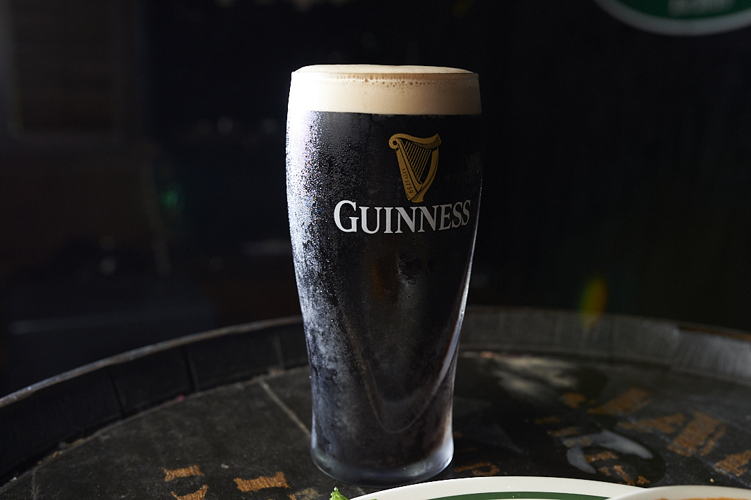 a cup of coffee and a glass of beer on a table