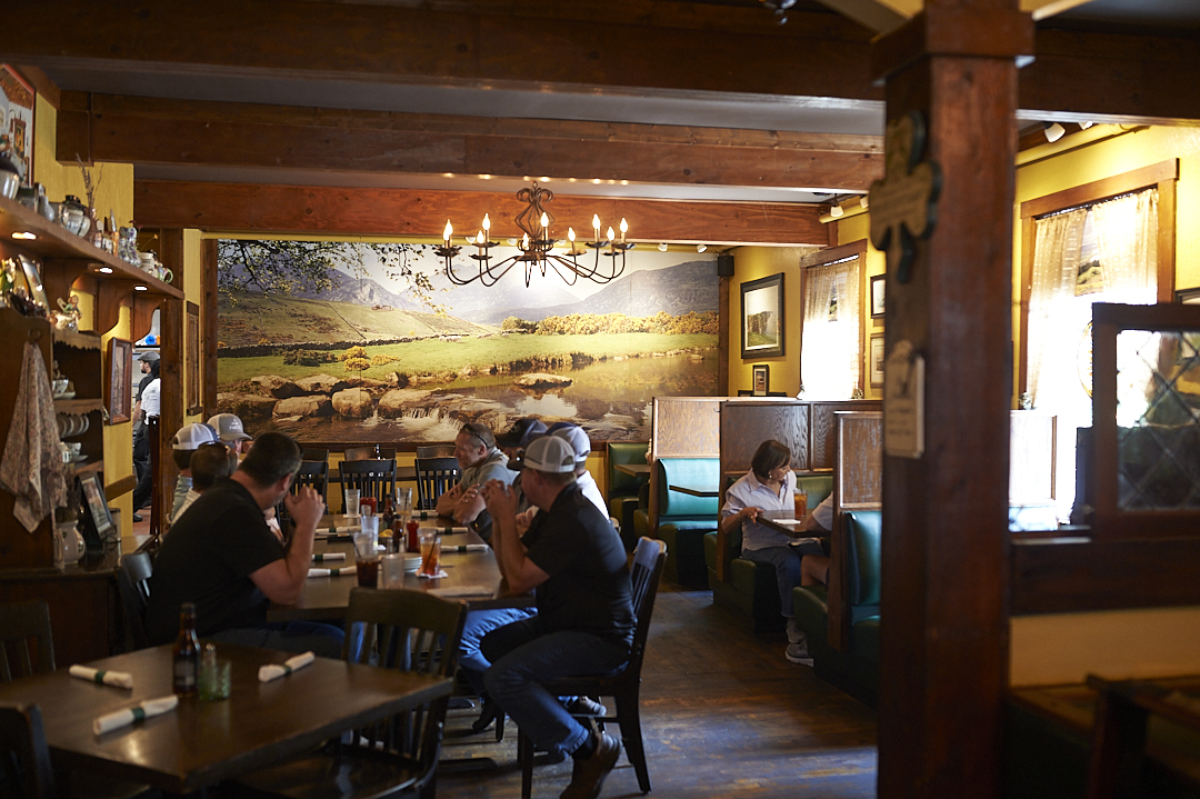a group of people sitting at a table in a restaurant