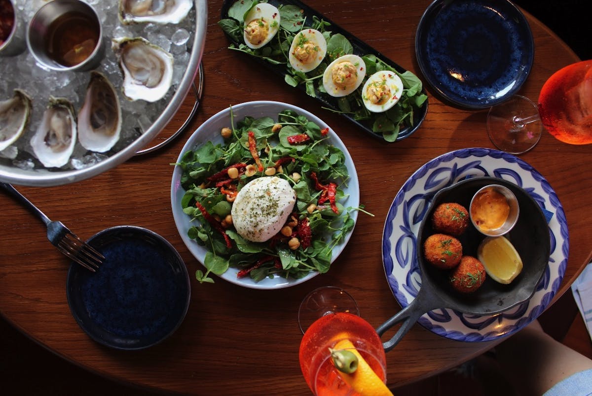 a plate of food sitting on top of a wooden table