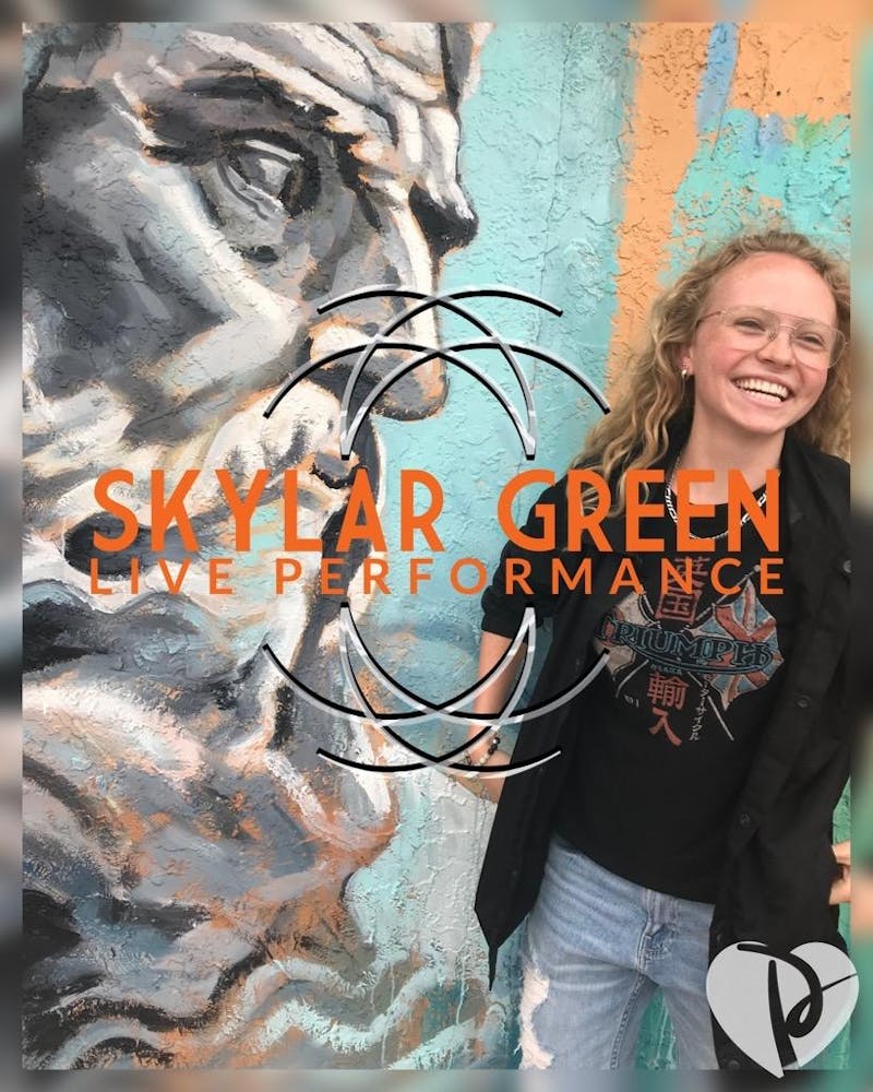 a person standing in front of a graffiti covered wall