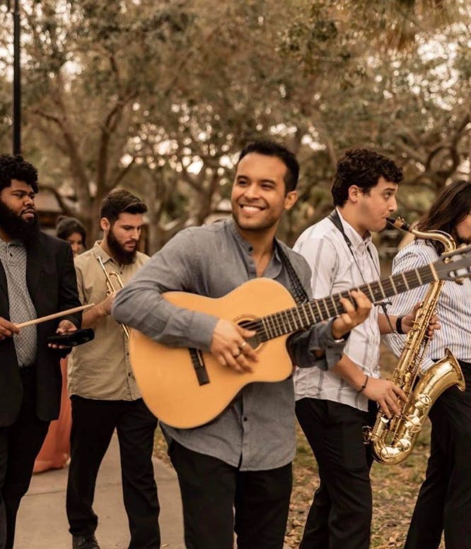 Andre Neblett, O.T. Fagbenle standing next to a guitar