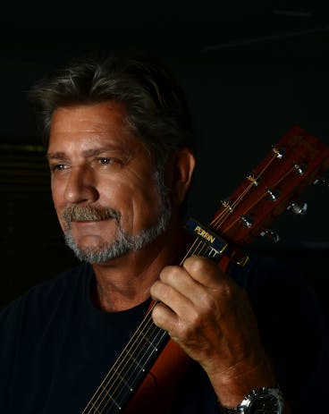 Paulo Szot holding a guitar