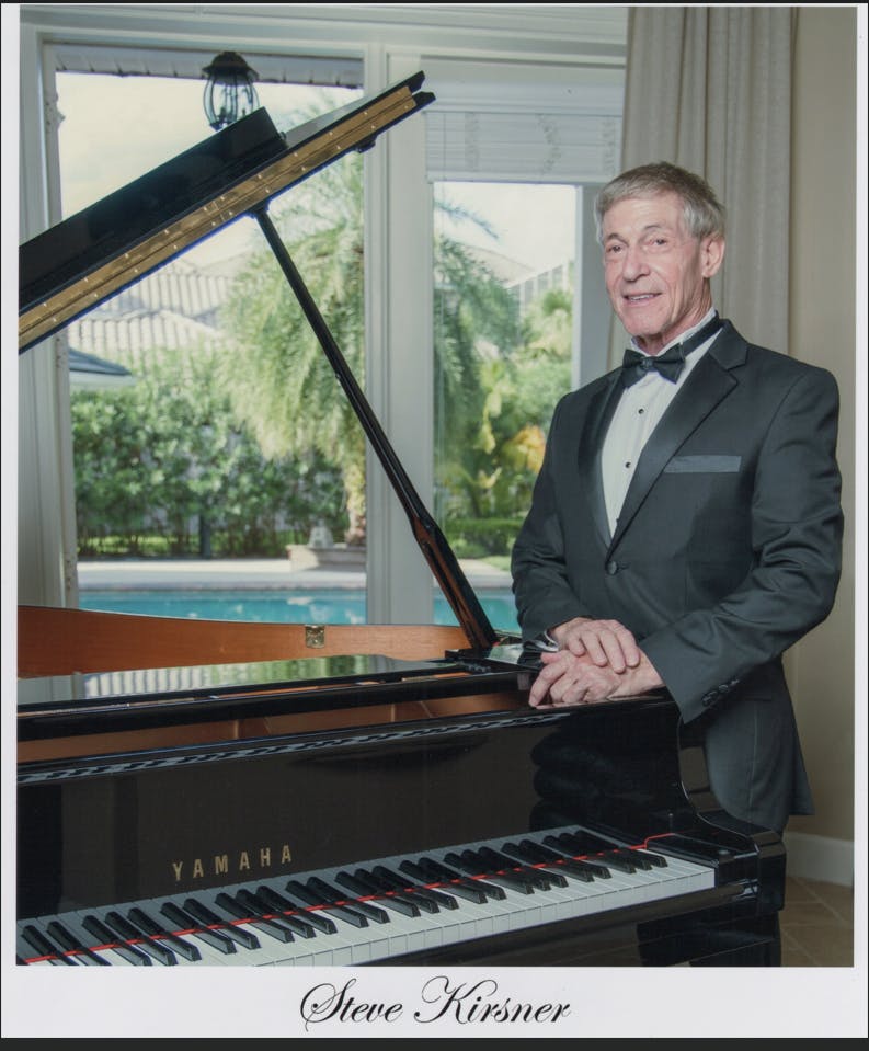 a man sitting in front of a piano