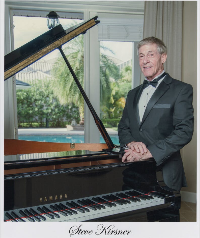 a man standing in front of a piano