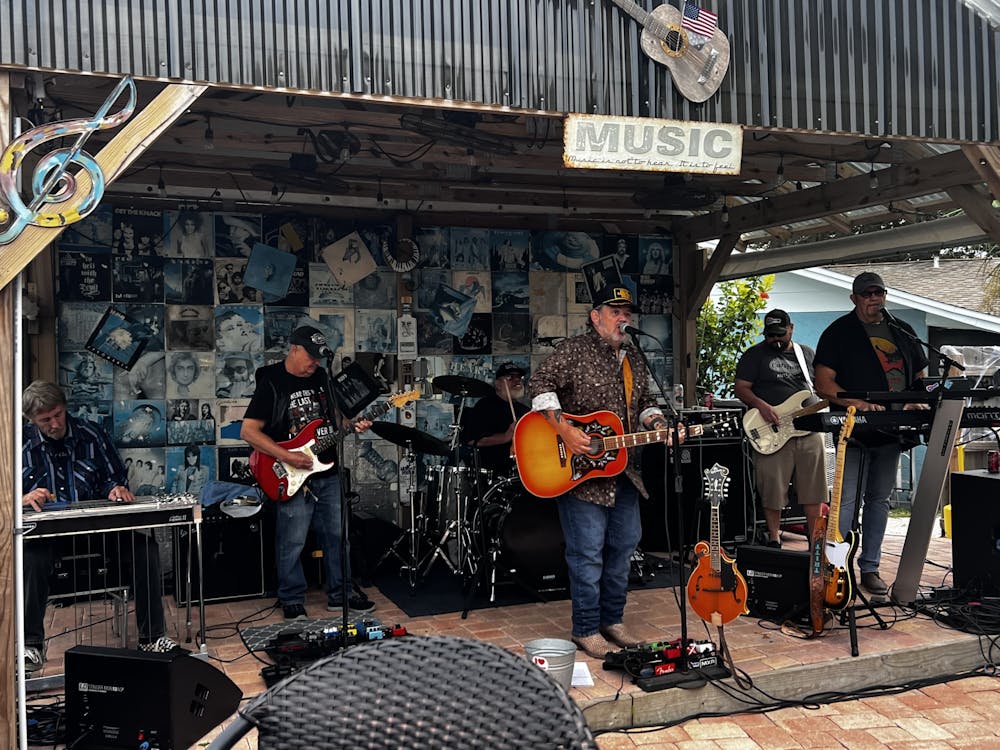 a group of people playing instruments and performing on a stage