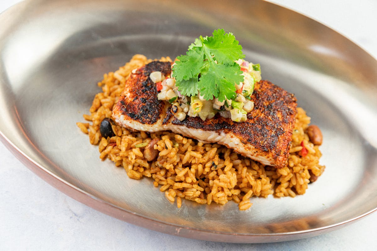 Chipotle swordfish on rice with corn avocado relish