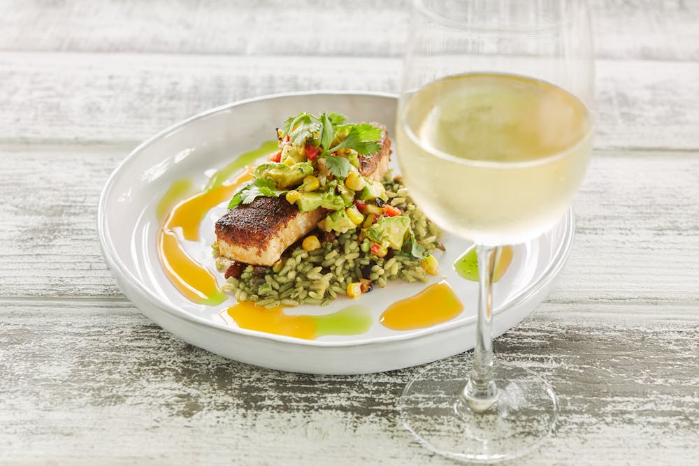 Blackened Swordfish, green rice and a glass of wine