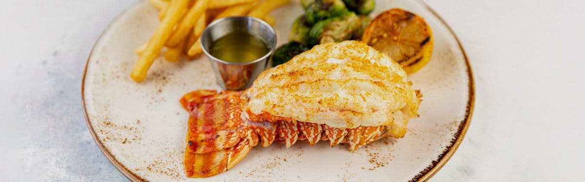 Lobster tail with brussel sprouts and fries