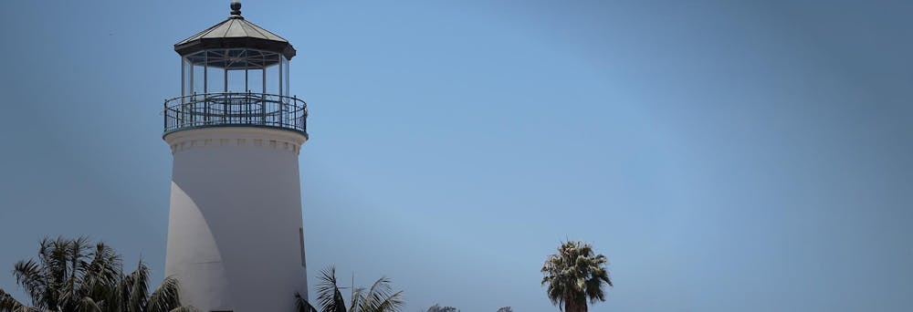 a clock tower next to a body of water