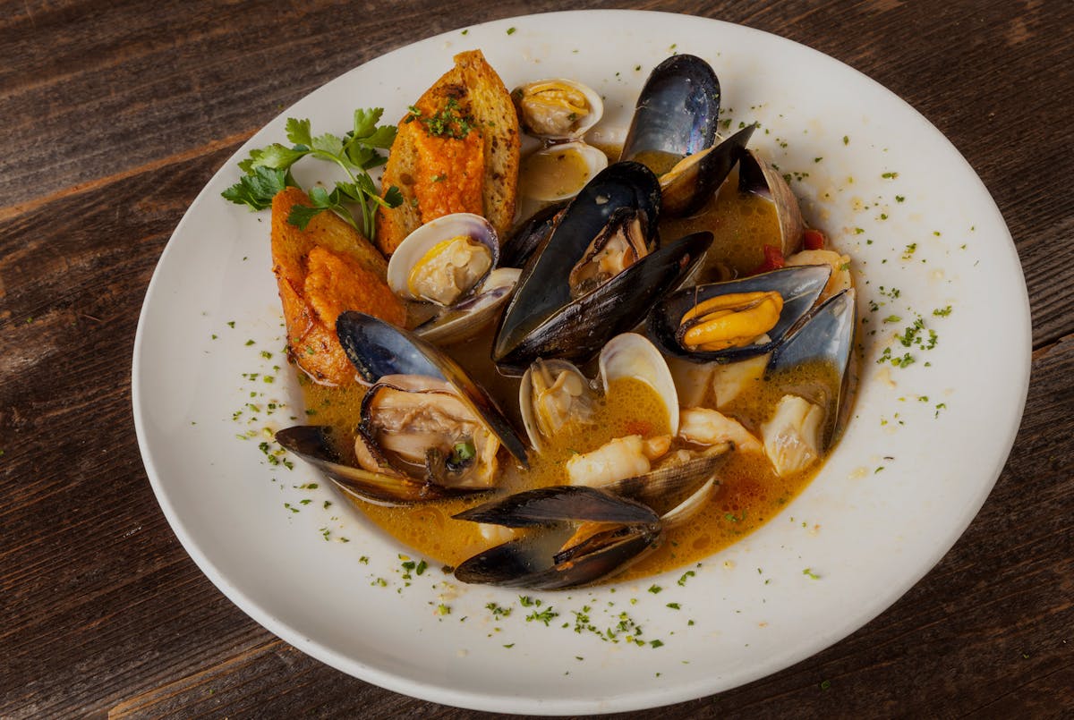 France’s Bouillabaisse  Provençal style saffron infused broth, fresh fish, mussels, clams, shrimp and scallops, with rouille