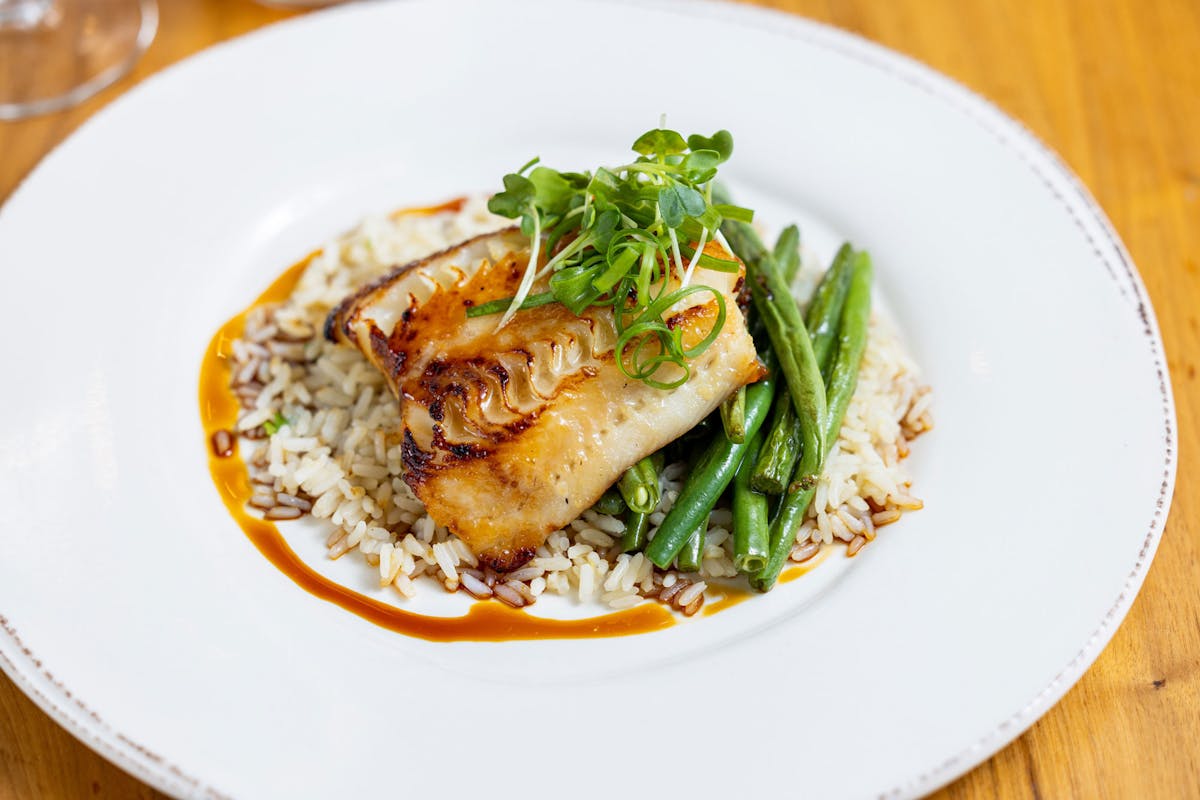 Misoyaki Glazed Cod with green beans, coconut rice and eel sauce with green onion and daikon sprouts