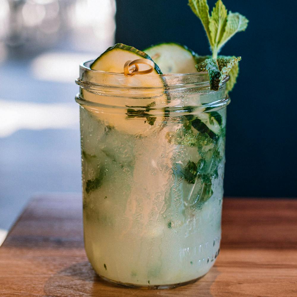 Cucumber mojito garnished with cucumber in a mason jar