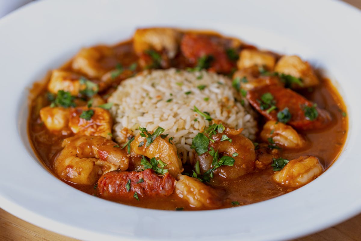 Shrimp & Chicken Gumbo, is served with andouille sausage okra, onions, peppers and celery, flavored with sassafras over rice