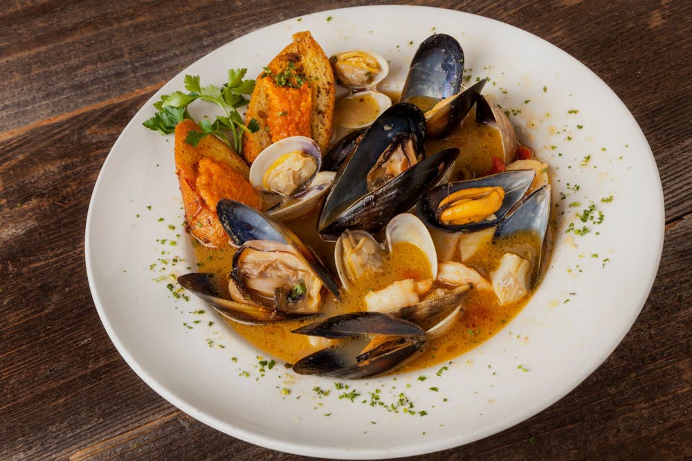 Bouillabaisse with a Provençal style saffron infused broth, fresh fish, mussels, clams, shrimp and scallops, with rouille