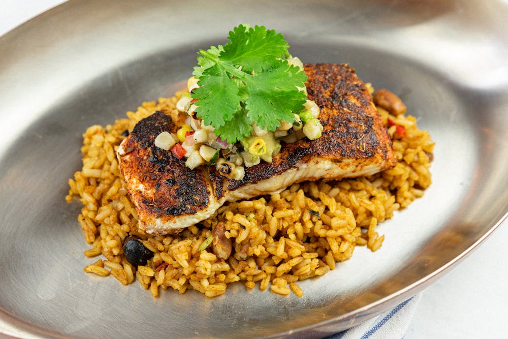 Chipotle swordfish on rice with corn avocado relish.