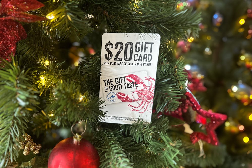 Bluewater gift card and holder hanging on Christmas tree.