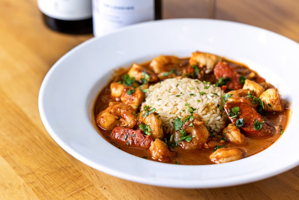 Shrimp & Chicken Gumbo, is served with andouille sausage okra, onions, peppers and celery, flavored with sassafras over rice