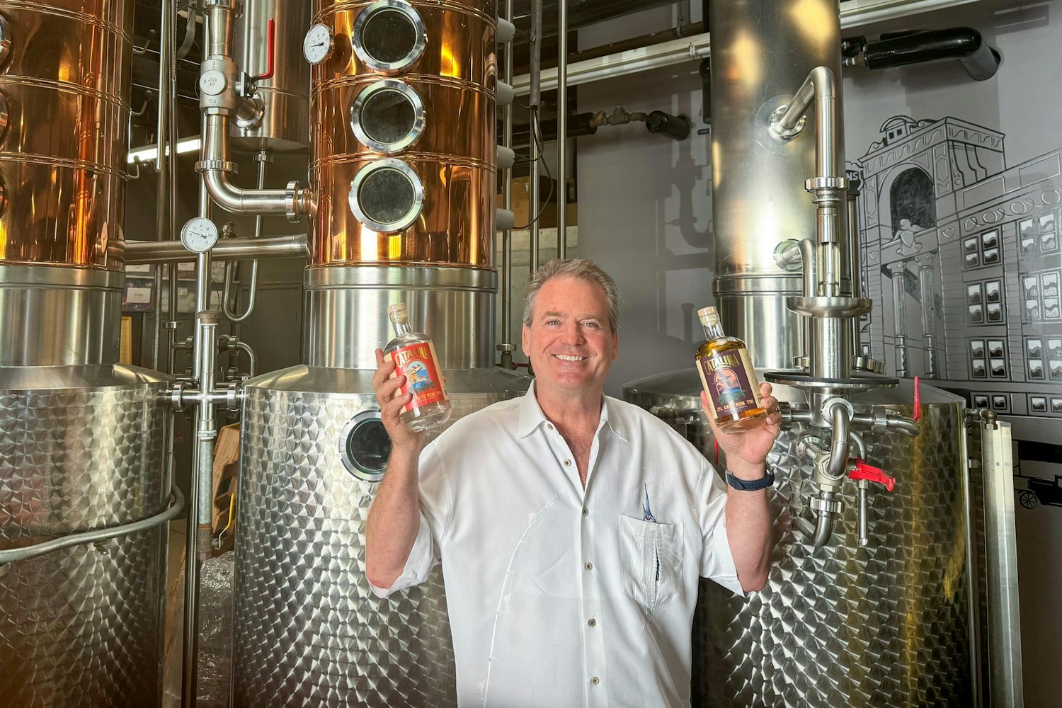 Jim Ulcickas, Co-Founder and Proprietor, holding two bottles of Bluewater's new Catalina Rum Company Light and Dark Rums.