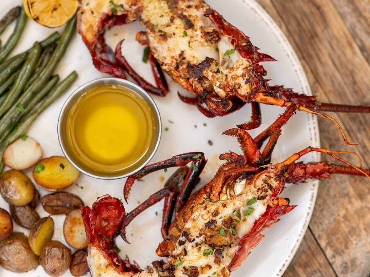 Spiny lobster split and flat grilled served with butter, green beans and potatoes.