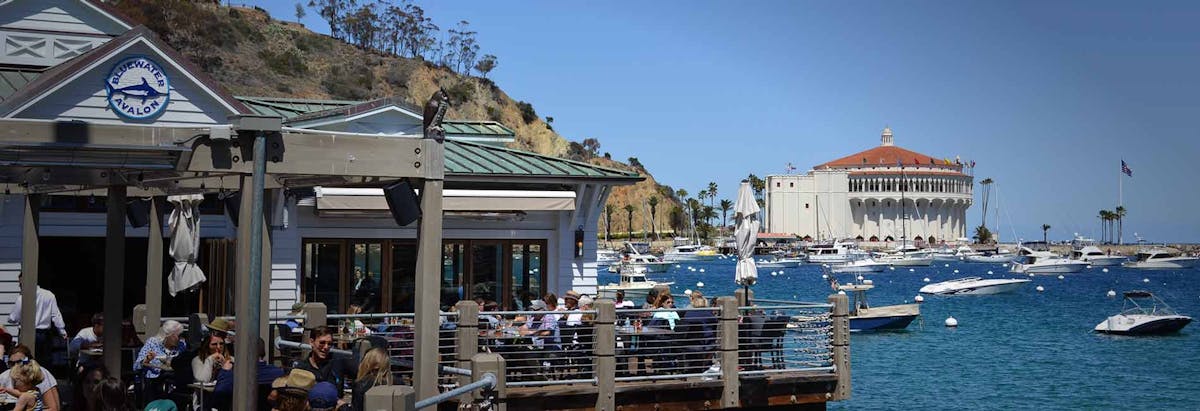 a group of people sitting at a dock