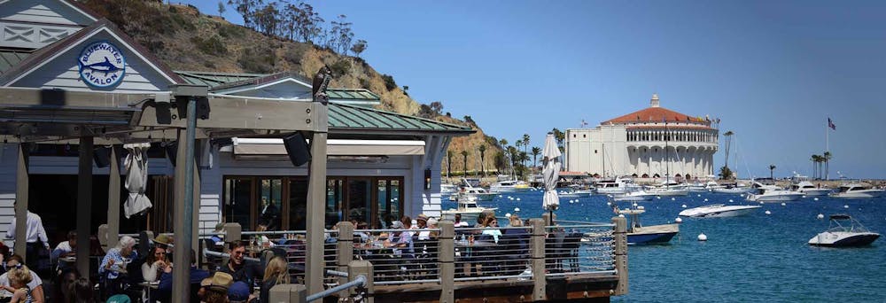 a group of people sitting at a dock
