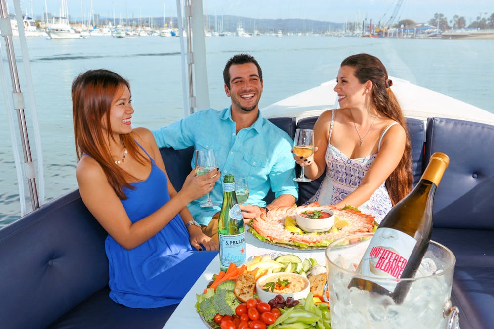 a woman sitting at a table in front of a body of water