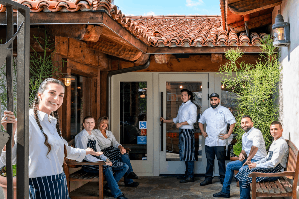 Exterior of Bluewater Grill Temecula with employees outside welcoming guests in