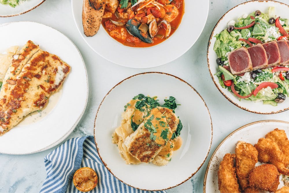 Variety of food dishes from Trout, Cioppino, Mahi Mahi, and tuna