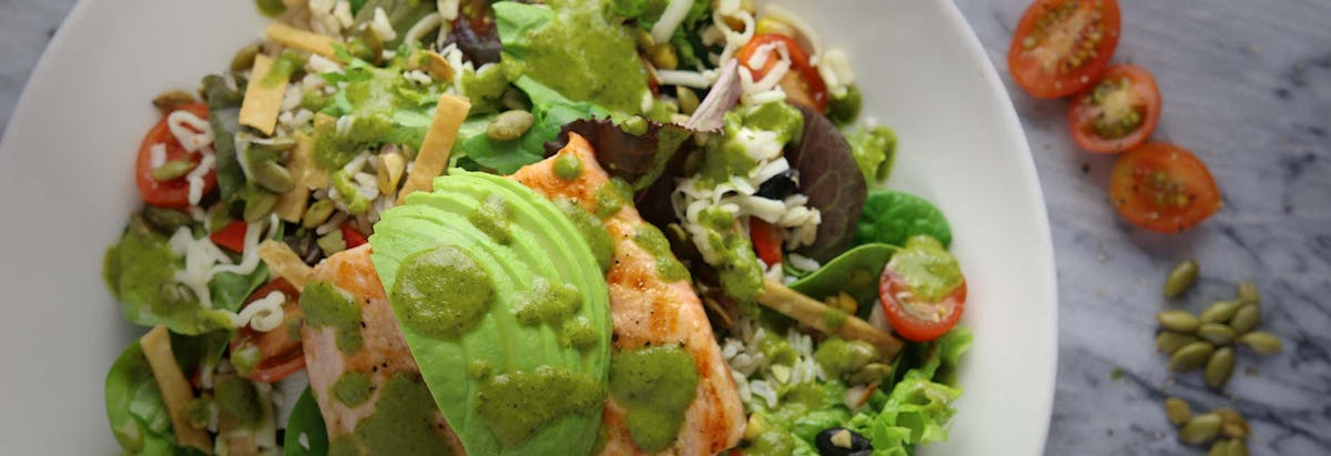 a plate of food with a green salad