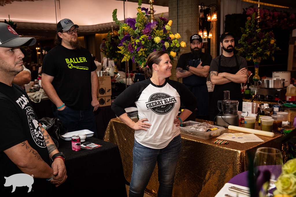 a group of people standing around a table