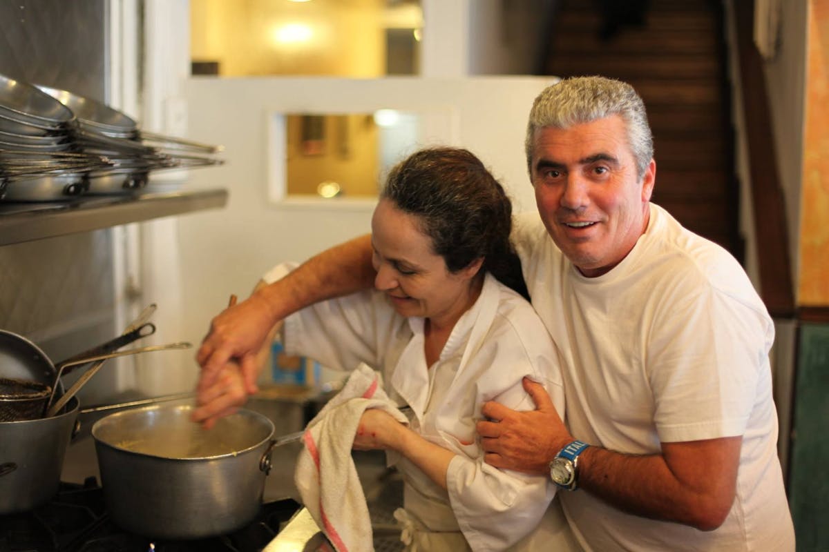 a man cooking in a kitchen preparing food