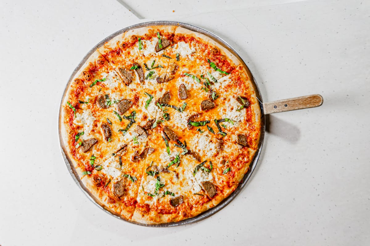 a pizza sitting on top of a pan on a table