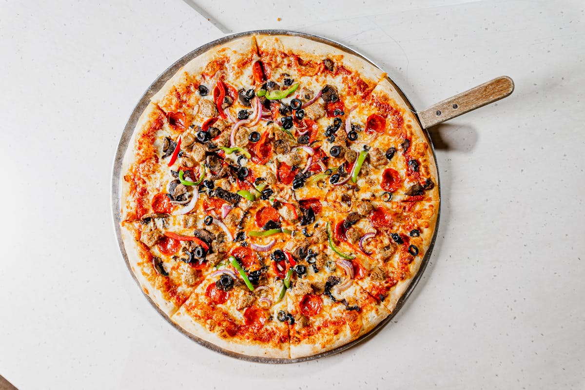a pizza sitting on top of a pan on a table