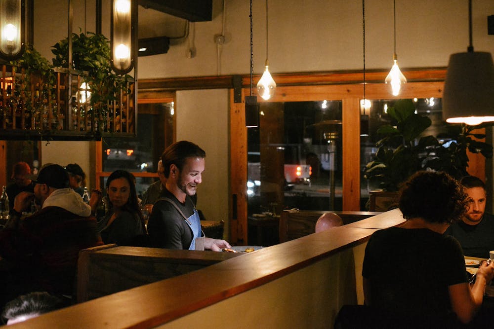 a group of people sitting at a table in a restaurant