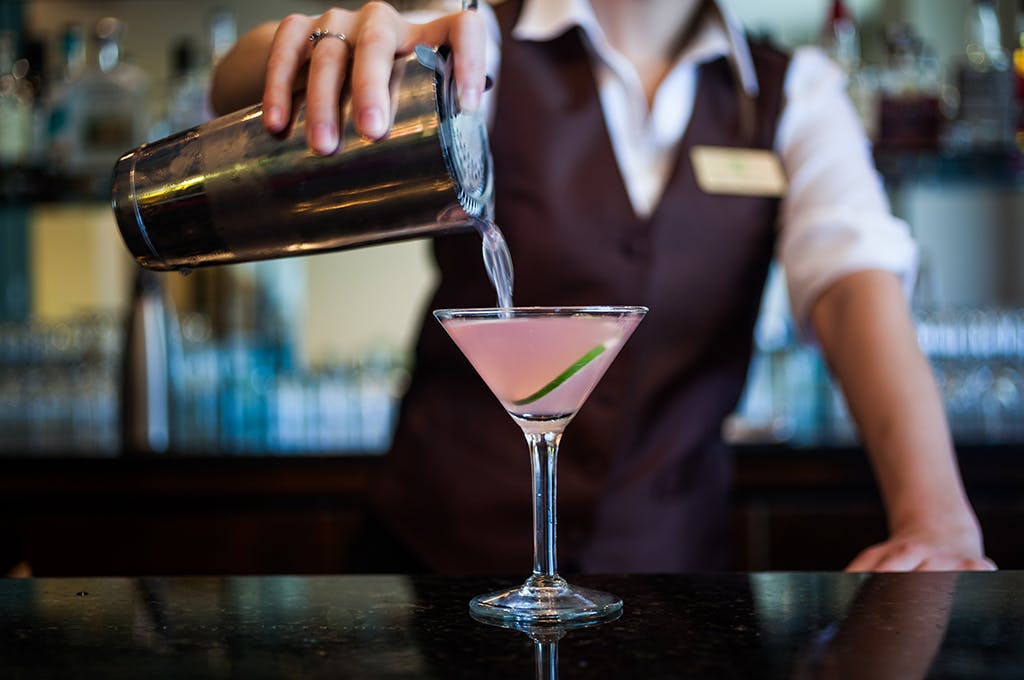 Bartender pouring a cocktail at The Tavern at American Bounty at the CIA in the Hudson Valley, NY.