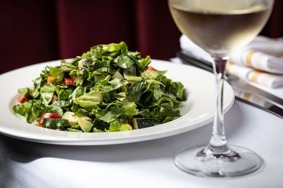 a plate of food and a glass of wine