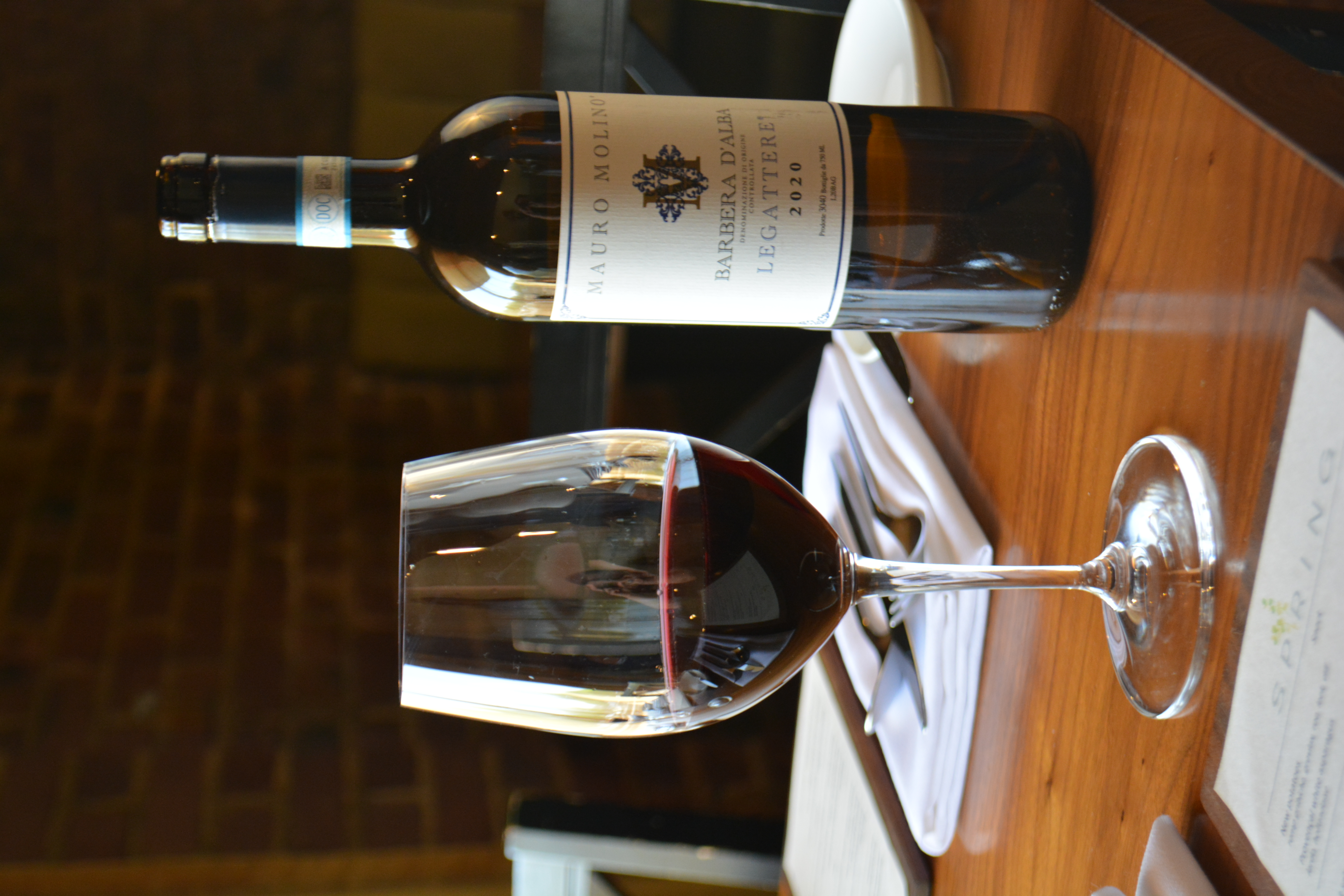 a bottle of wine sitting on top of a wooden table