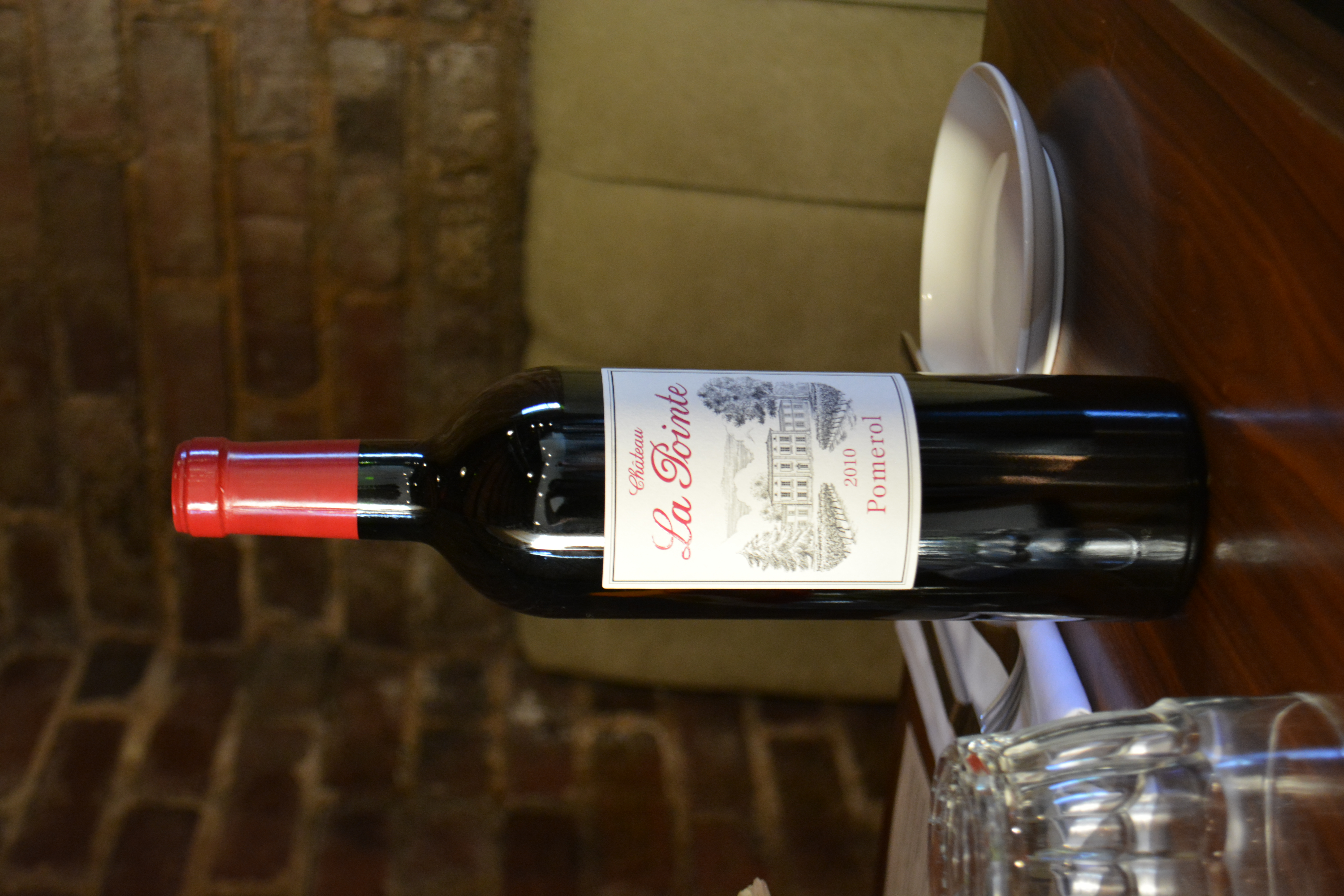 a bottle of wine and a glass of beer on a table