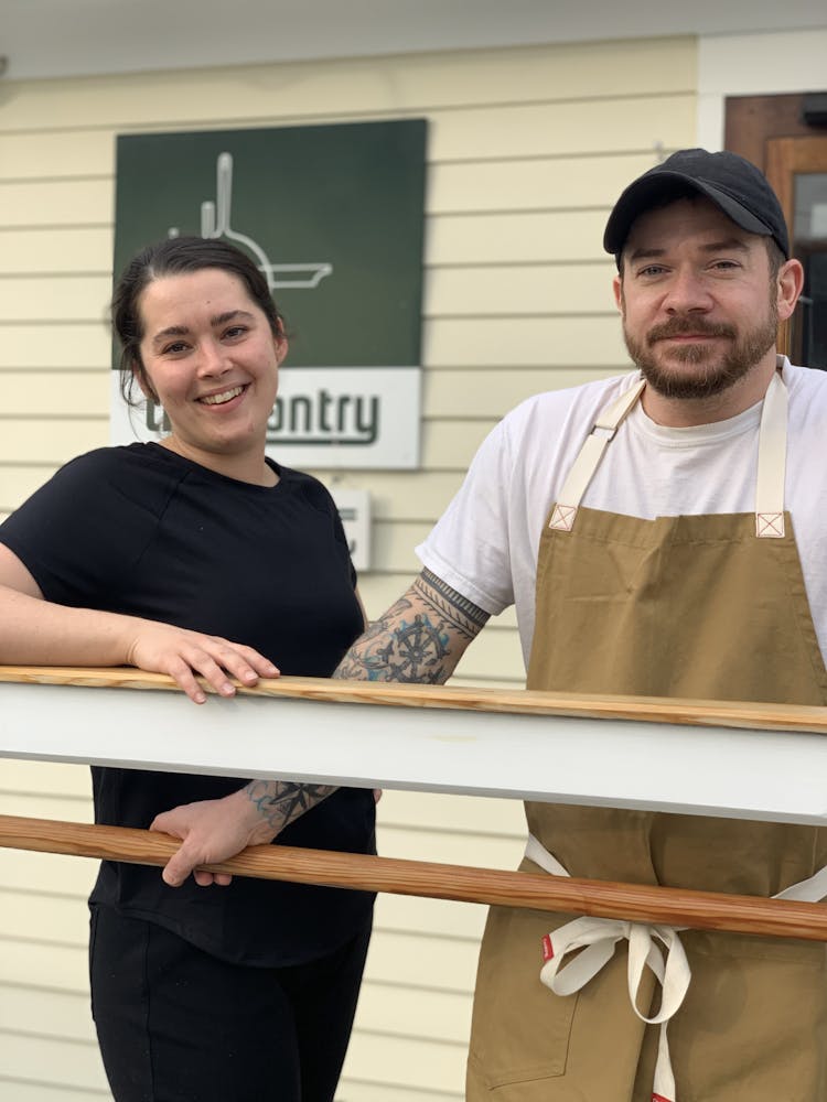a man and a woman standing in front of a building
