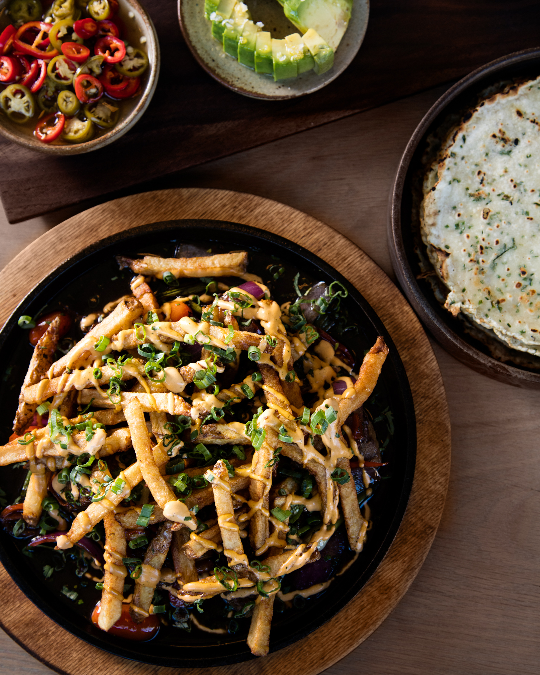 a bowl of food sitting on top of a wooden table